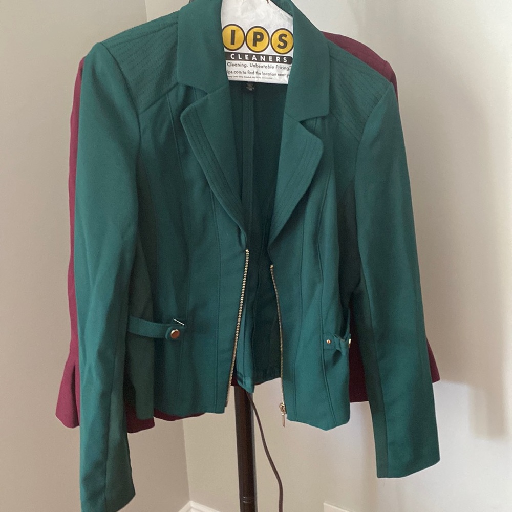 green zip up jacket with gold accents